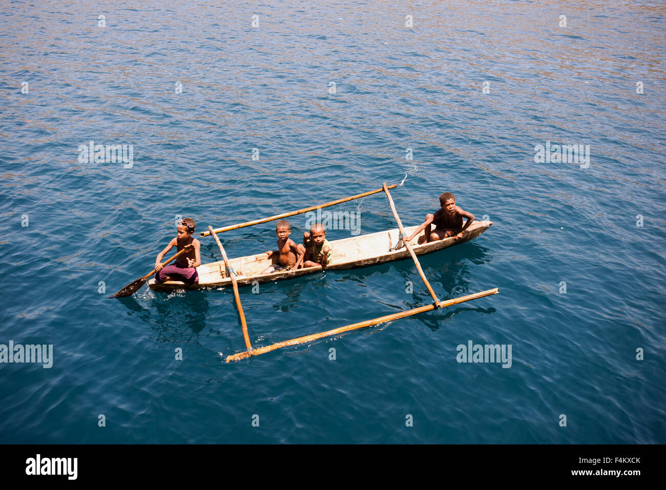 Indonesian boys in a dugout canoe Pantar Island Indonesia Stock Photo