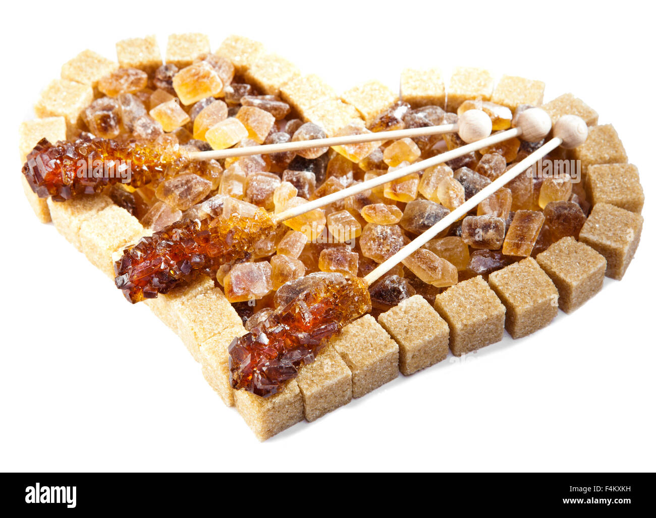 Heart from not refined reed sugar and candy sugar on a stick Stock Photo