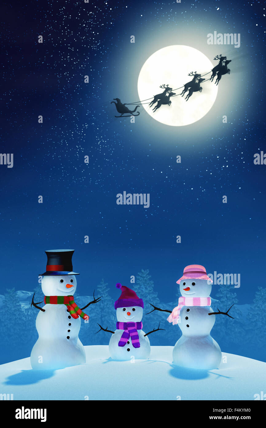 A snowman family in a snowy Christmas landscape at night. The scene is lit by the light of a