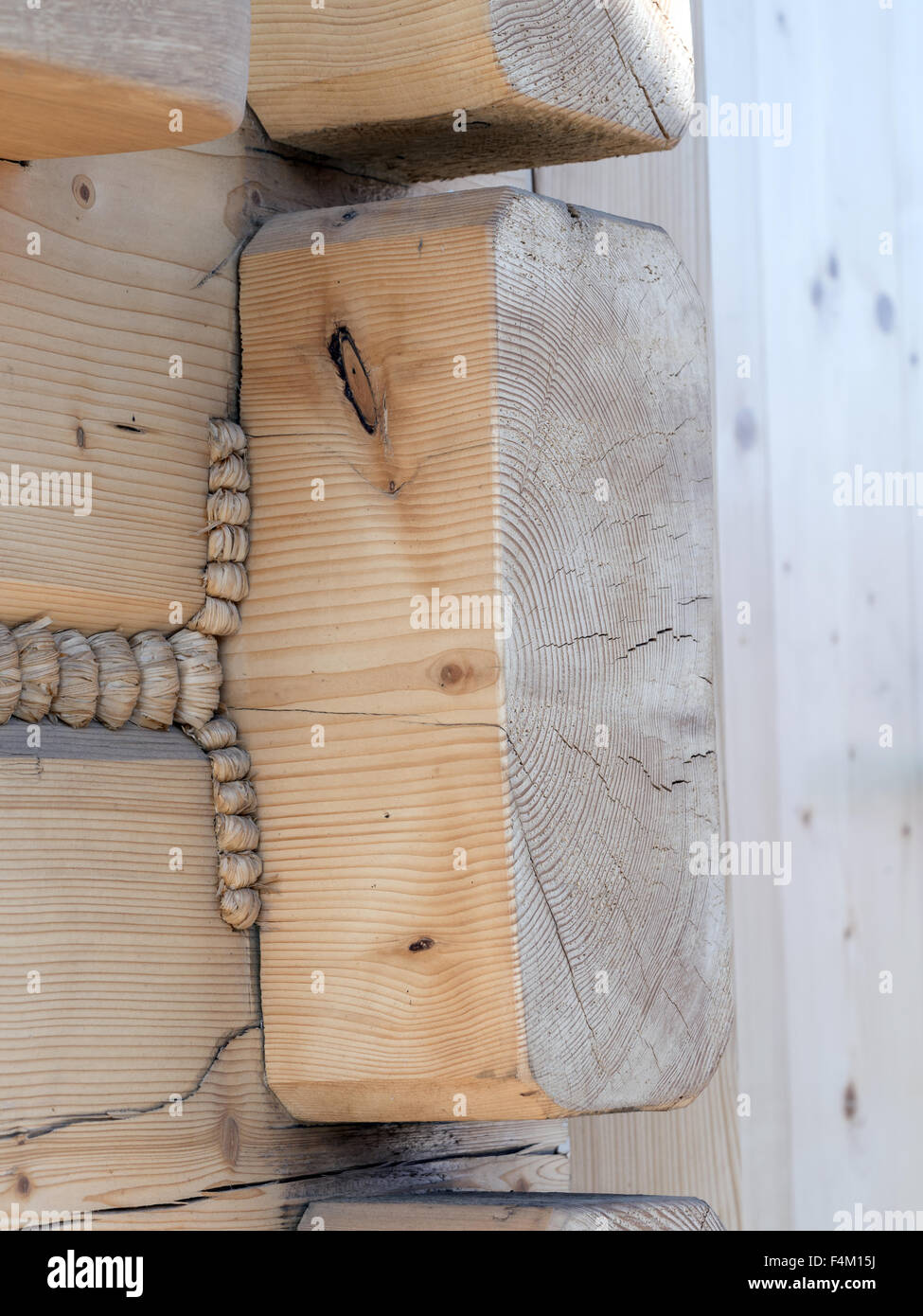 Closeup of wooden cabin wall corner joints with hemp rope sealant Stock Photo