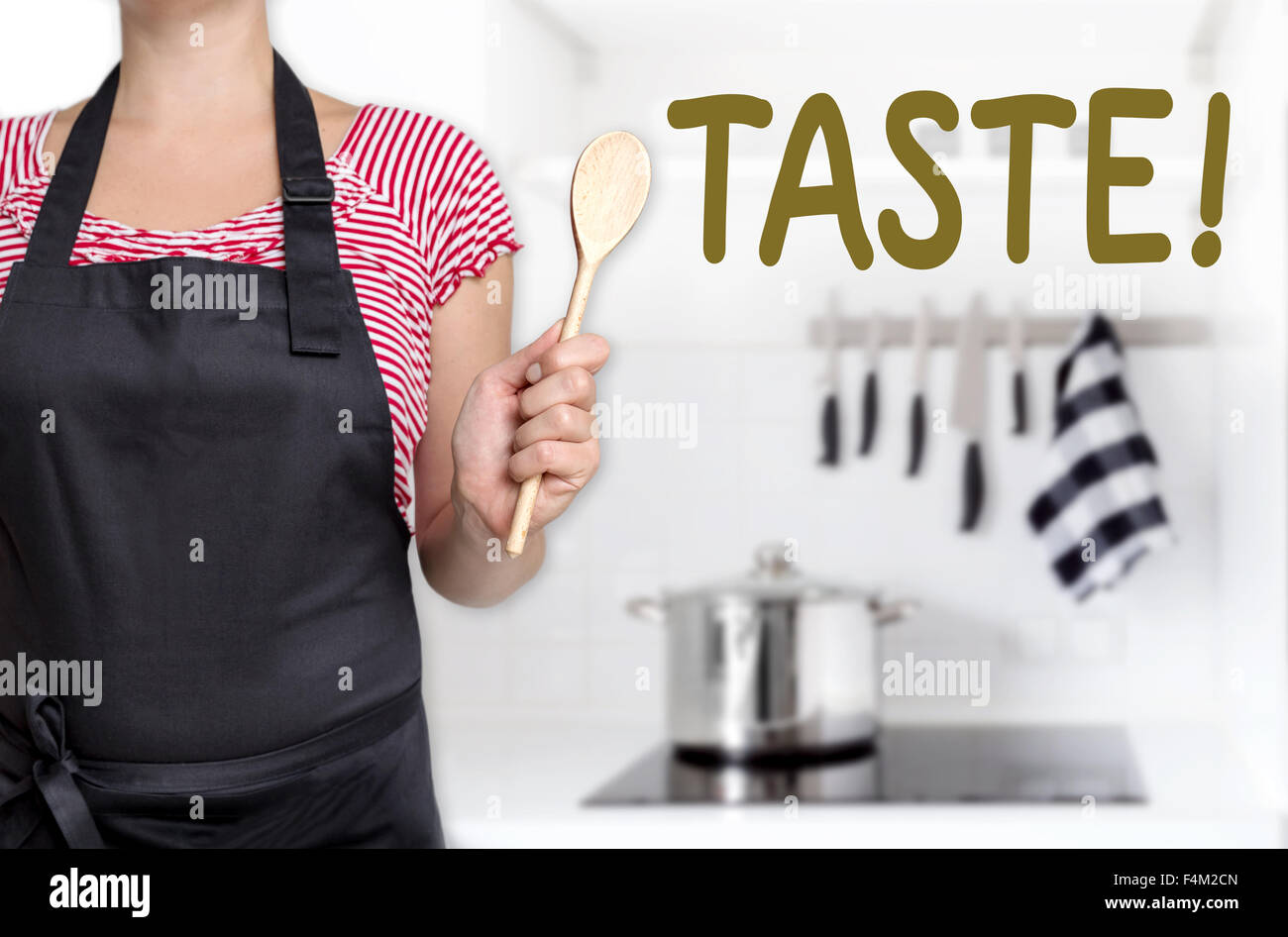 taste cook holding wooden spoon background concept. Stock Photo