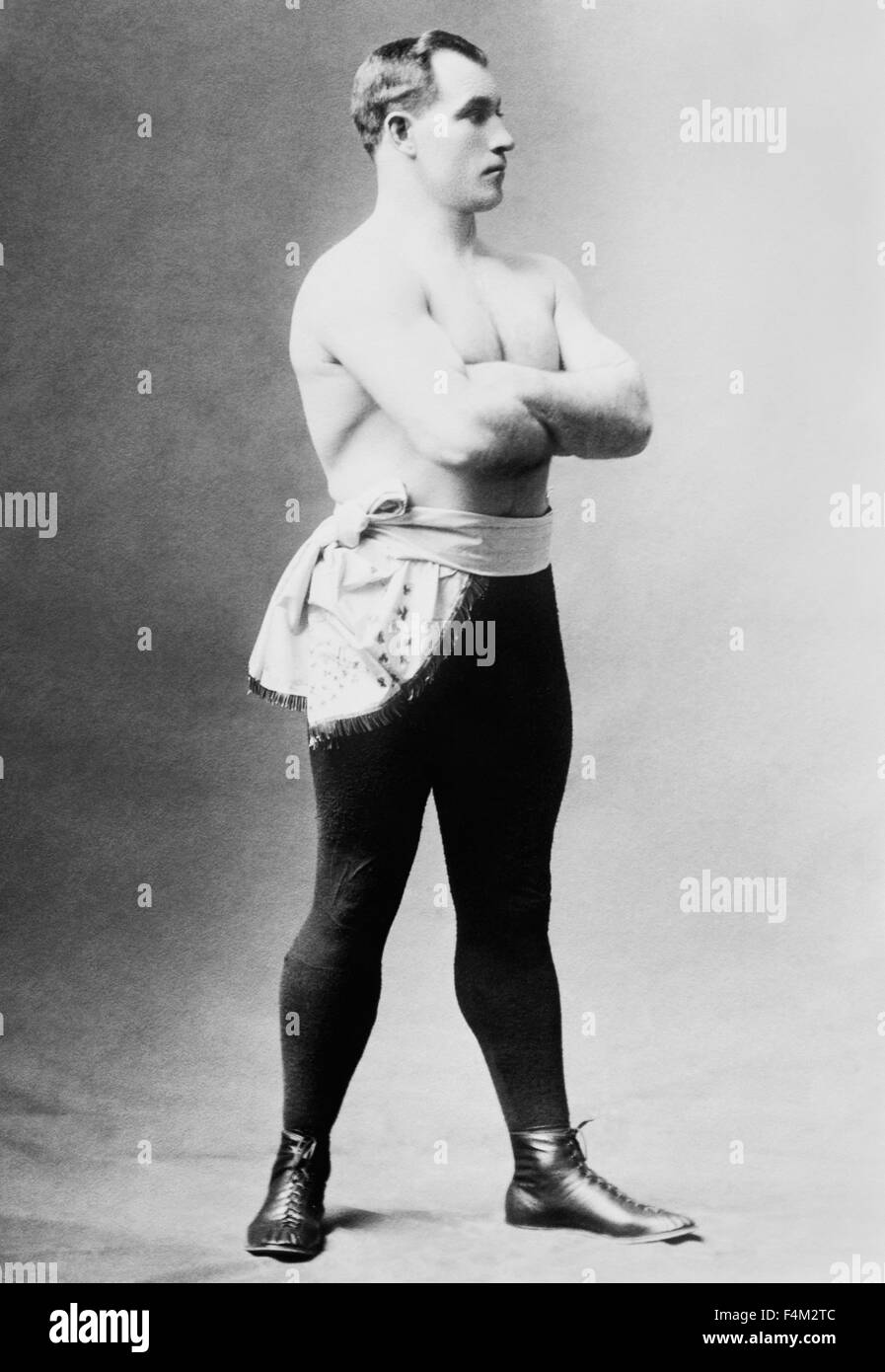 Vintage portrait photo of heavyweight boxer 'Sailor' Tom Sharkey (1873 - 1953). Sharkey, born in Dundalk, Ireland, ran away from home at a young age and went to sea as a cabin boy, eventually arriving in New York City in 1892 and joining the US Navy. He began his boxing career after being deployed to Hawaii and went on to have more than 50 bouts - fighting some of the great champions of the era including Jim Corbett, Bob Fitzsimmons and Jim Jeffries. Despite never winning the world heavyweight crown Sharkey is generally regarded as one of the great fighters of his time. Stock Photo