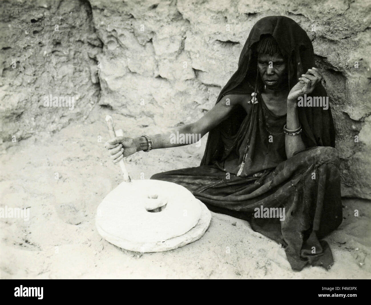 Women grinding corn hi-res stock photography and images - Alamy