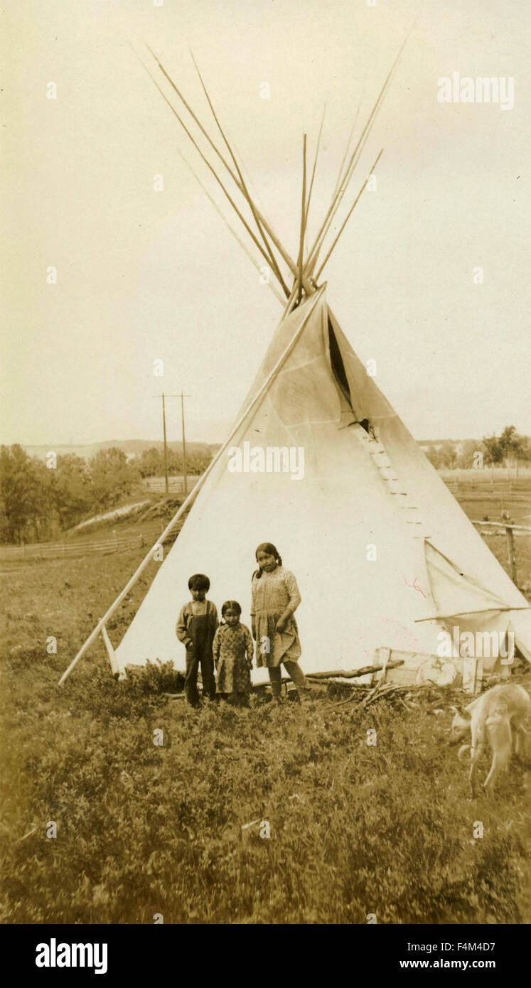 Three Native American Indian children next to the tent, Canada Stock Photo