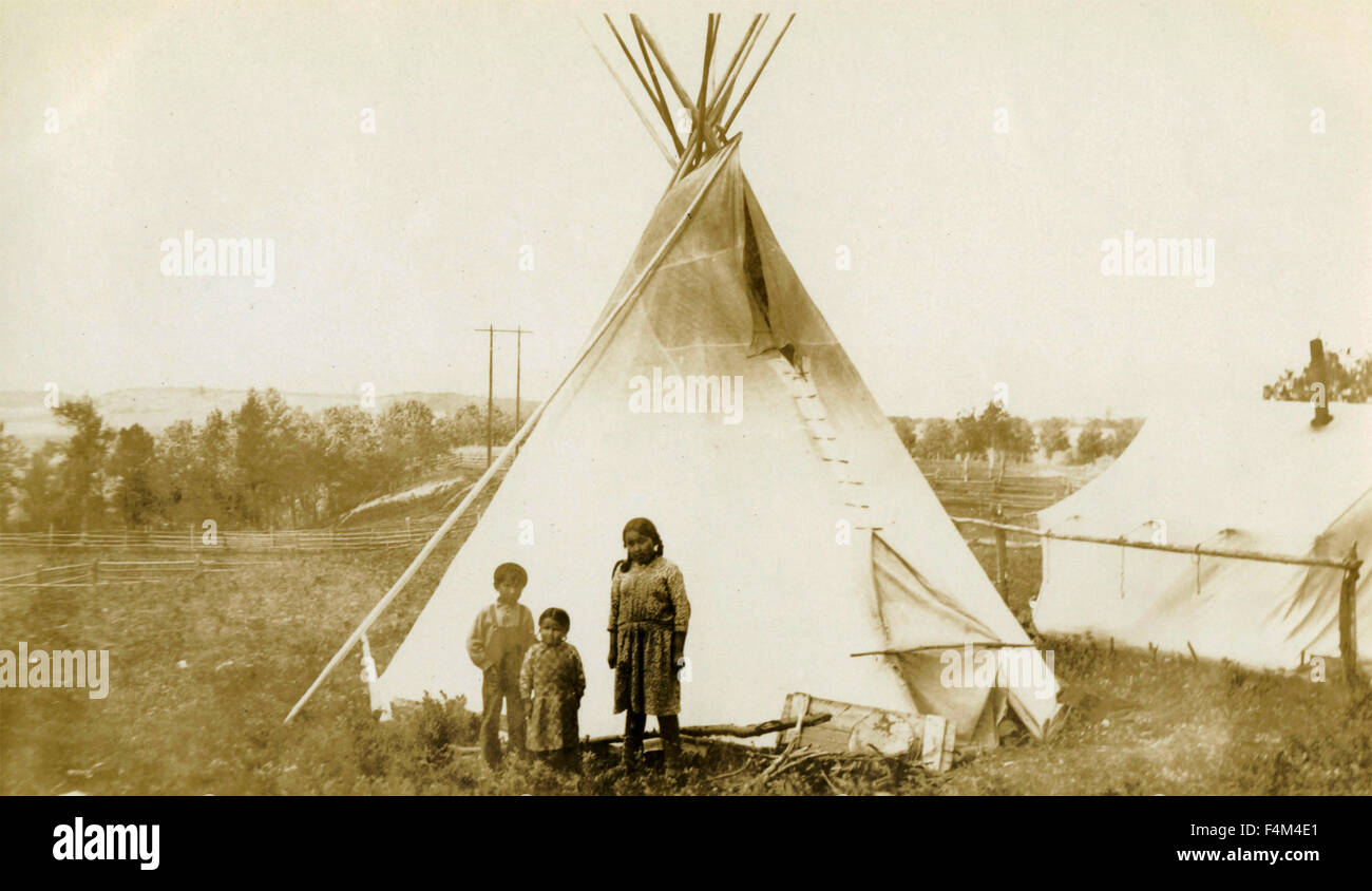 Three Native American Indian children next to the tent, Canada Stock Photo