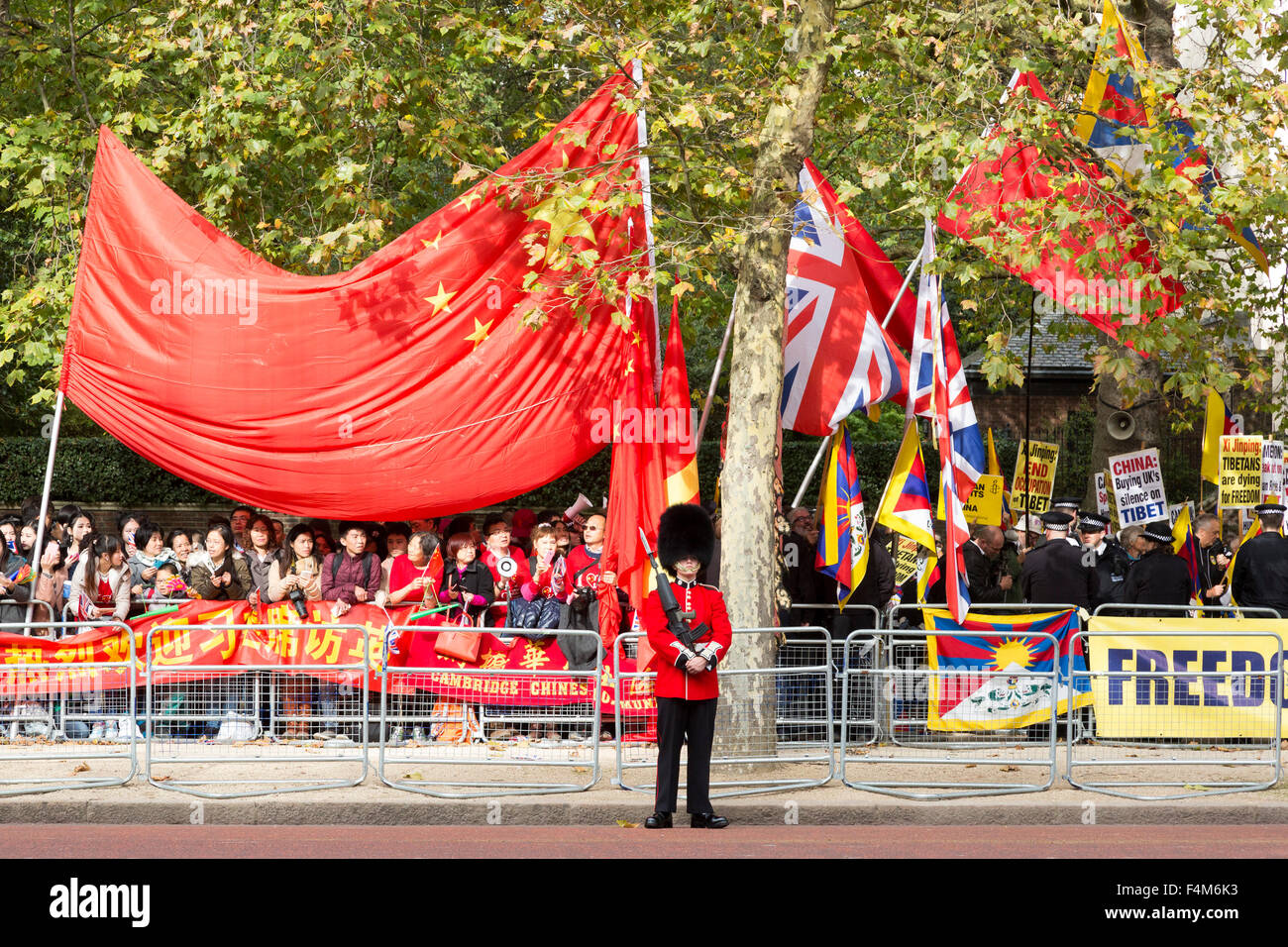 London, UK. 20th October, 2015. A Queen's Guard stands between pro and anti China protesters. State visit of the Chinese President Xi Jinping in London. Credit:  bas/Alamy Live News Stock Photo