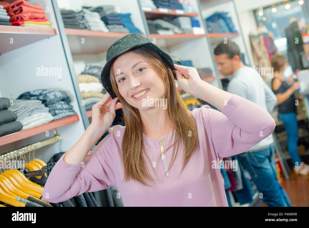 Lady trying on hat Stock Photo