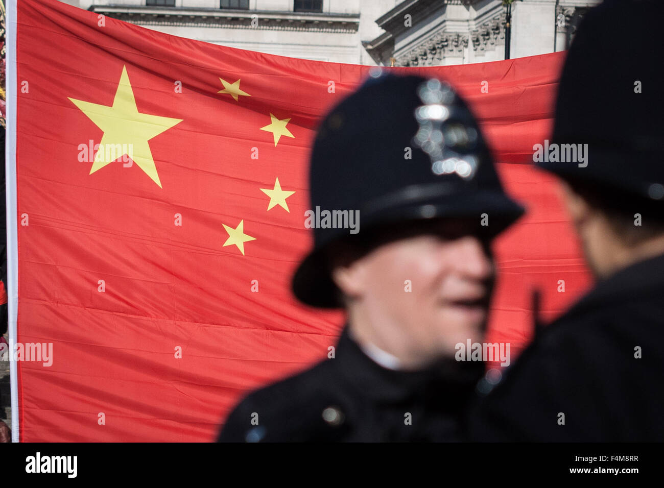 London, UK. 20th October, 2015. Chinese supporters wait for President Xi Jinping as part of the Queen’s Royal welcoming procession down The Mall beginning his state visit Credit:  Guy Corbishley/Alamy Live News Stock Photo