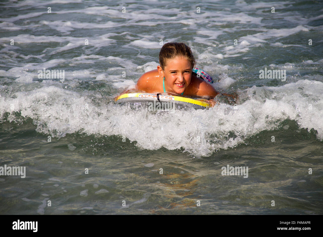 happy girl in the sea with tablet surf Stock Photo