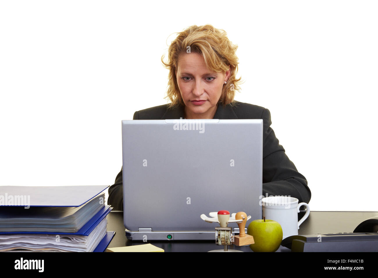Business woman sitting with laptop at her desk Stock Photo