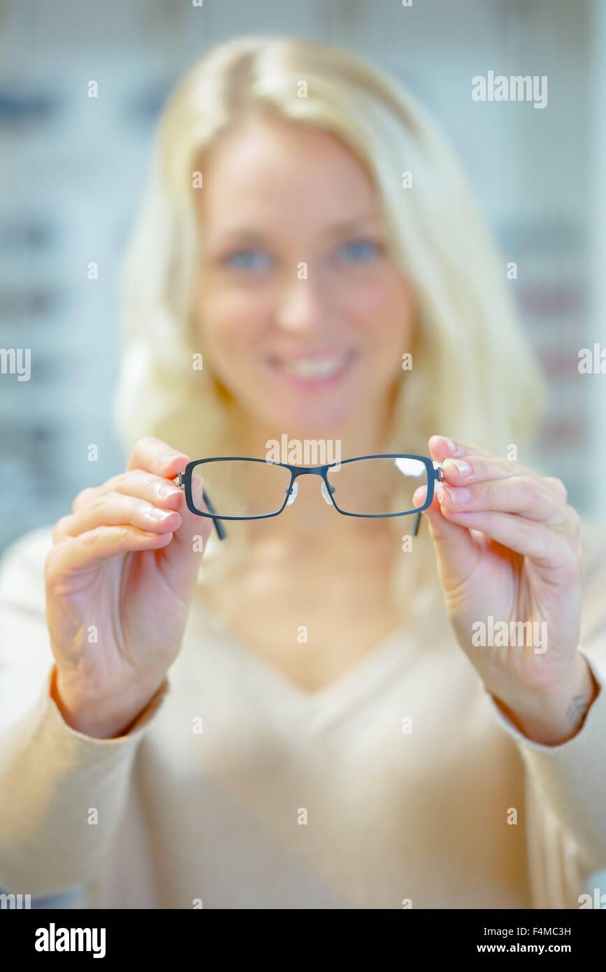 Woman trying on a pair of glasses Stock Photo Alamy