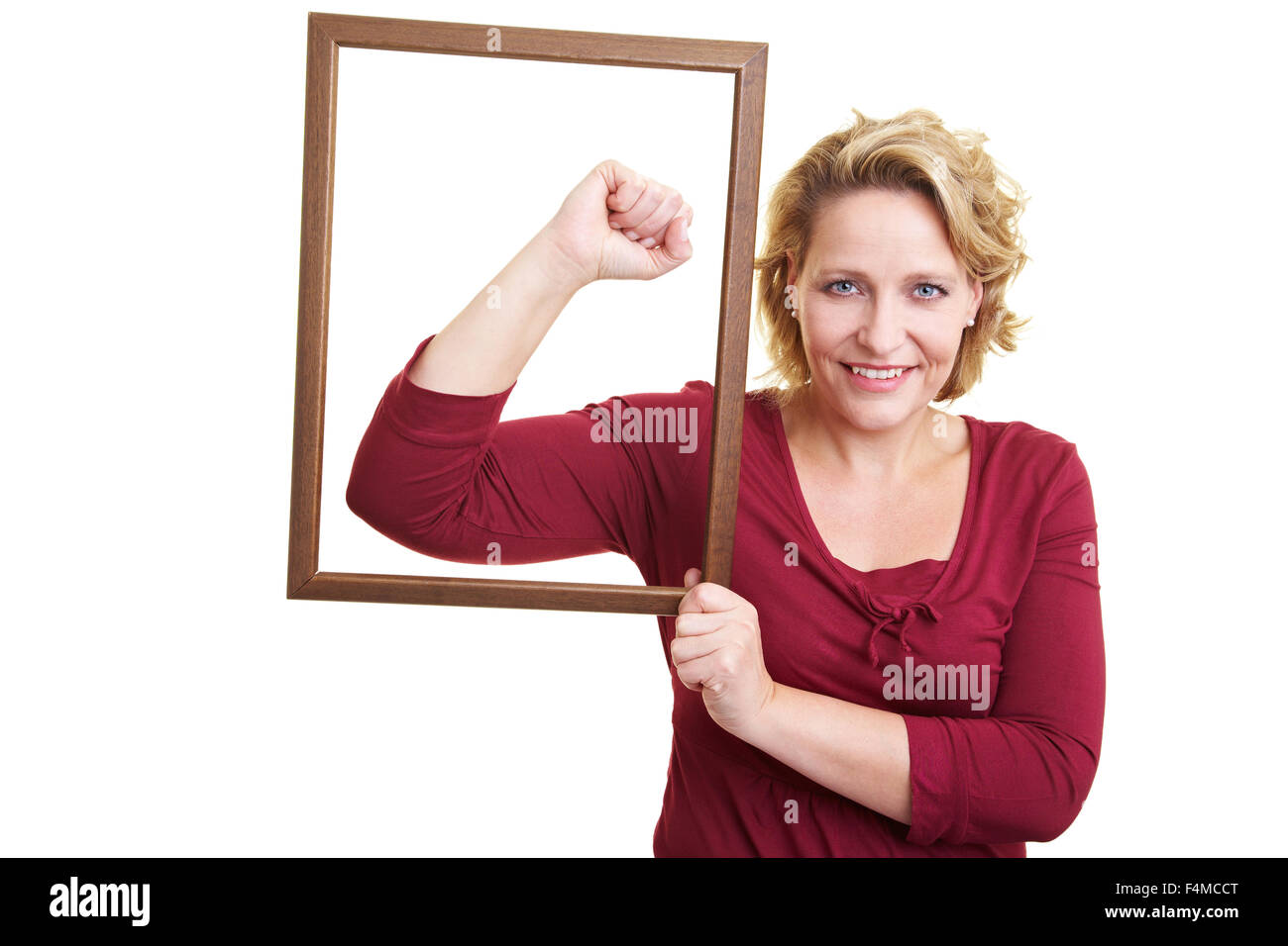 Woman holding an empty frame in front of her arm muscles Stock Photo