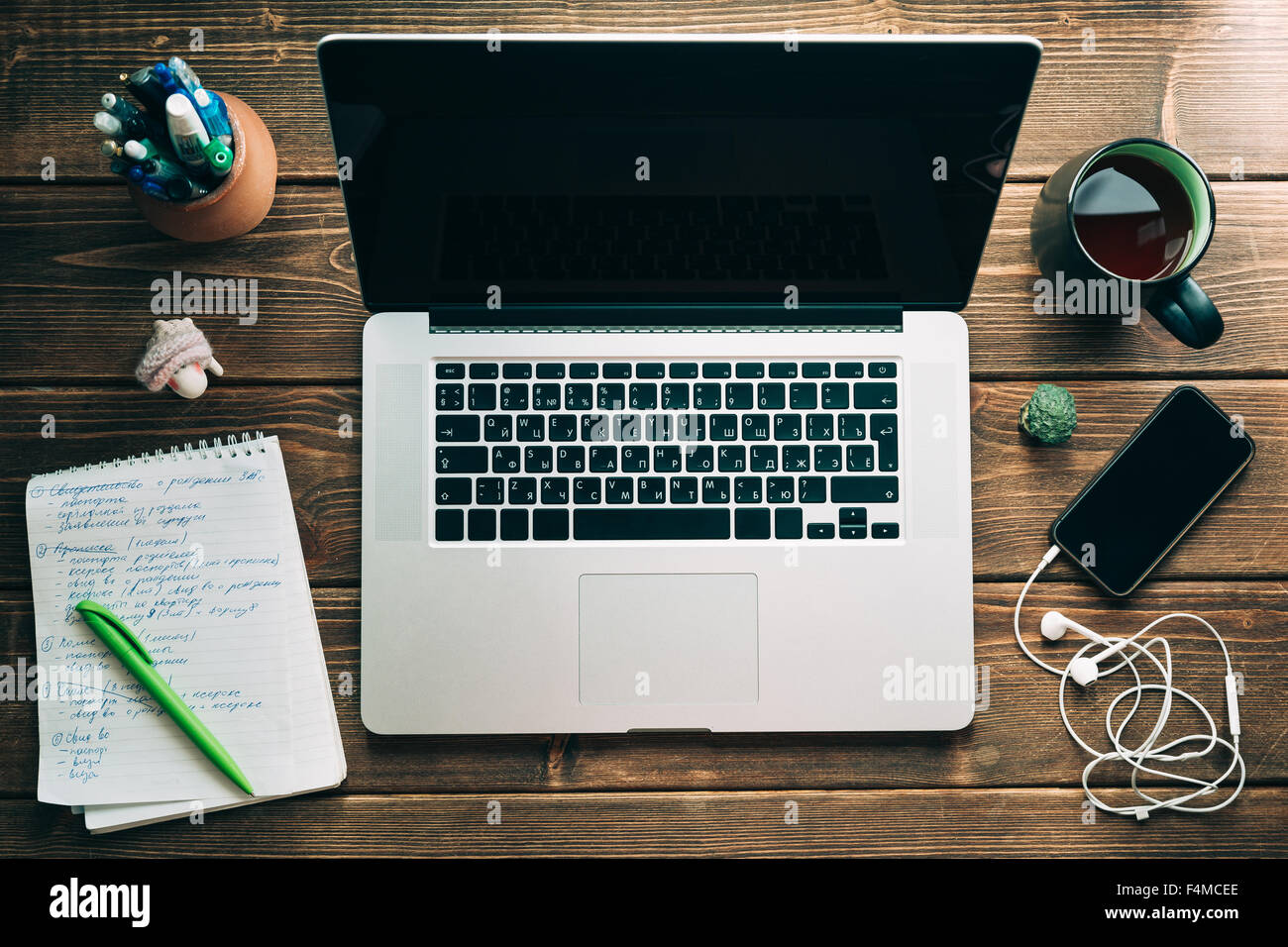 Workplace with open laptop on modern wooden desk Stock Photo - Alamy