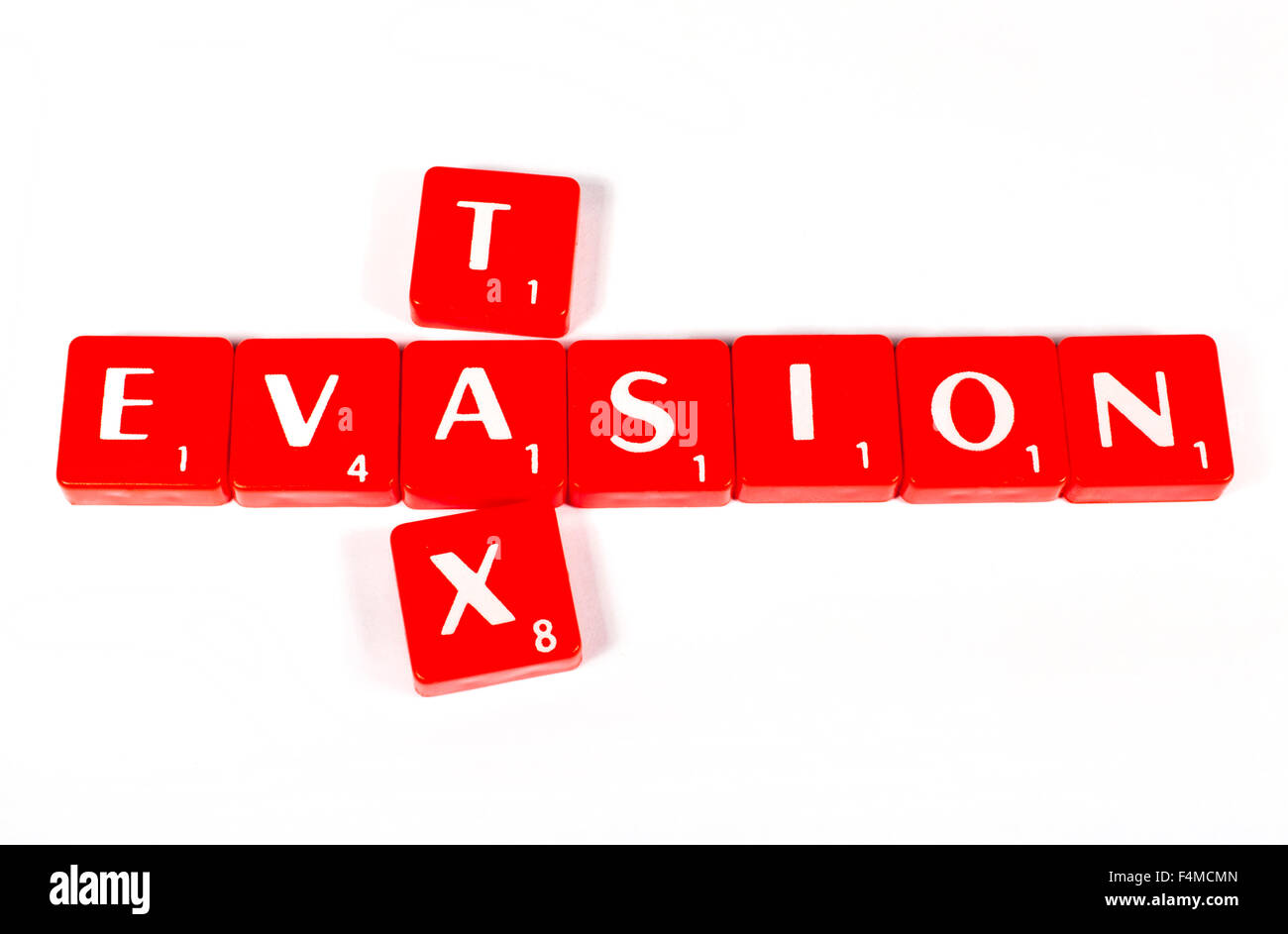 TAX EVASION spelt out in red lettered tiles. Stock Photo
