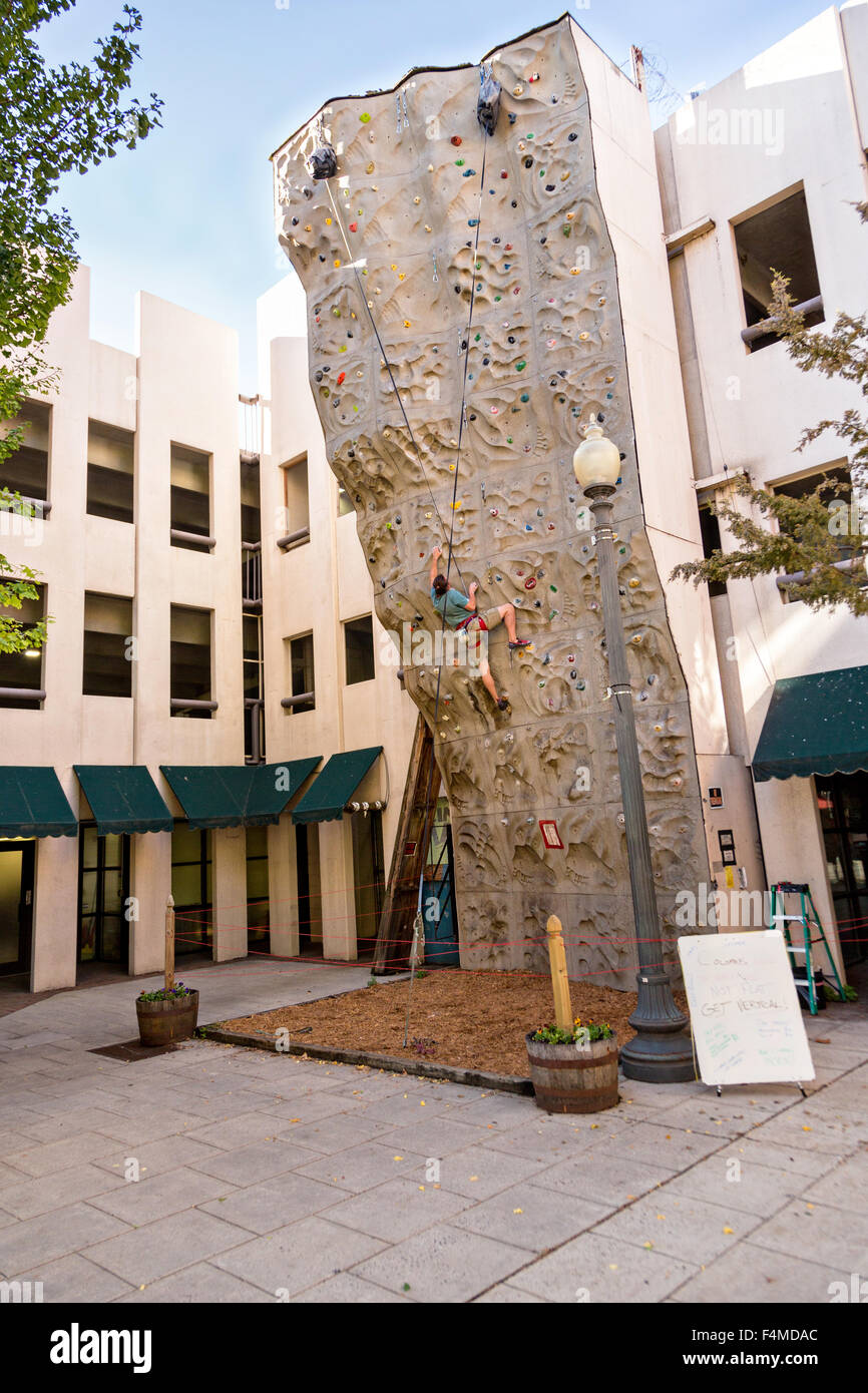 A man climbs a rock climbing wall in downtown Asheville, North Carolina