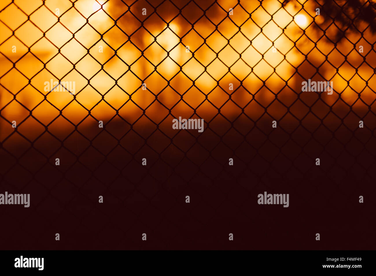 Mesh fence close-up on a blurred background Stock Photo - Alamy