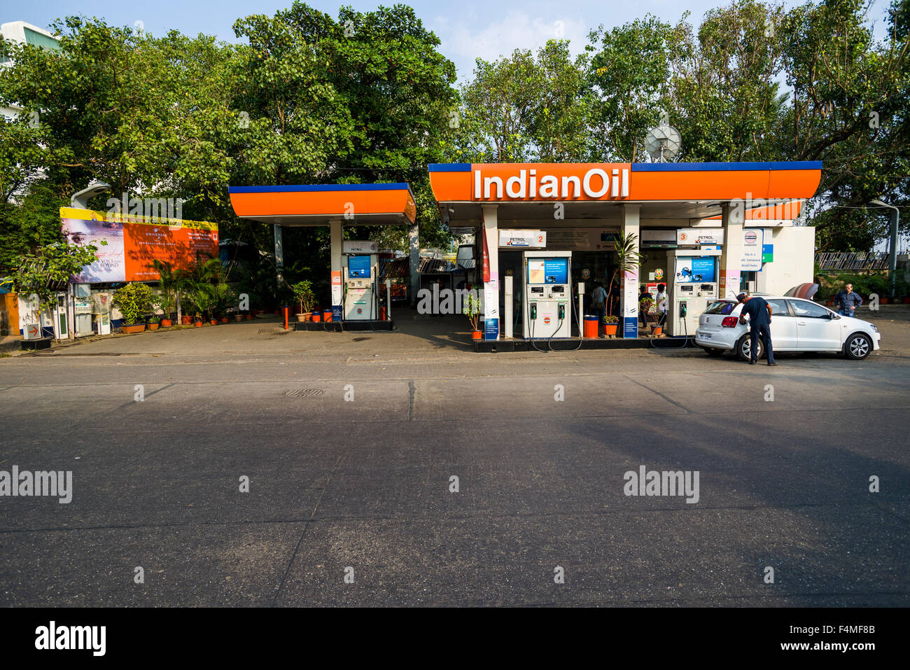 An Indian Oil petrol station with a white car filling up petrol Stock Photo