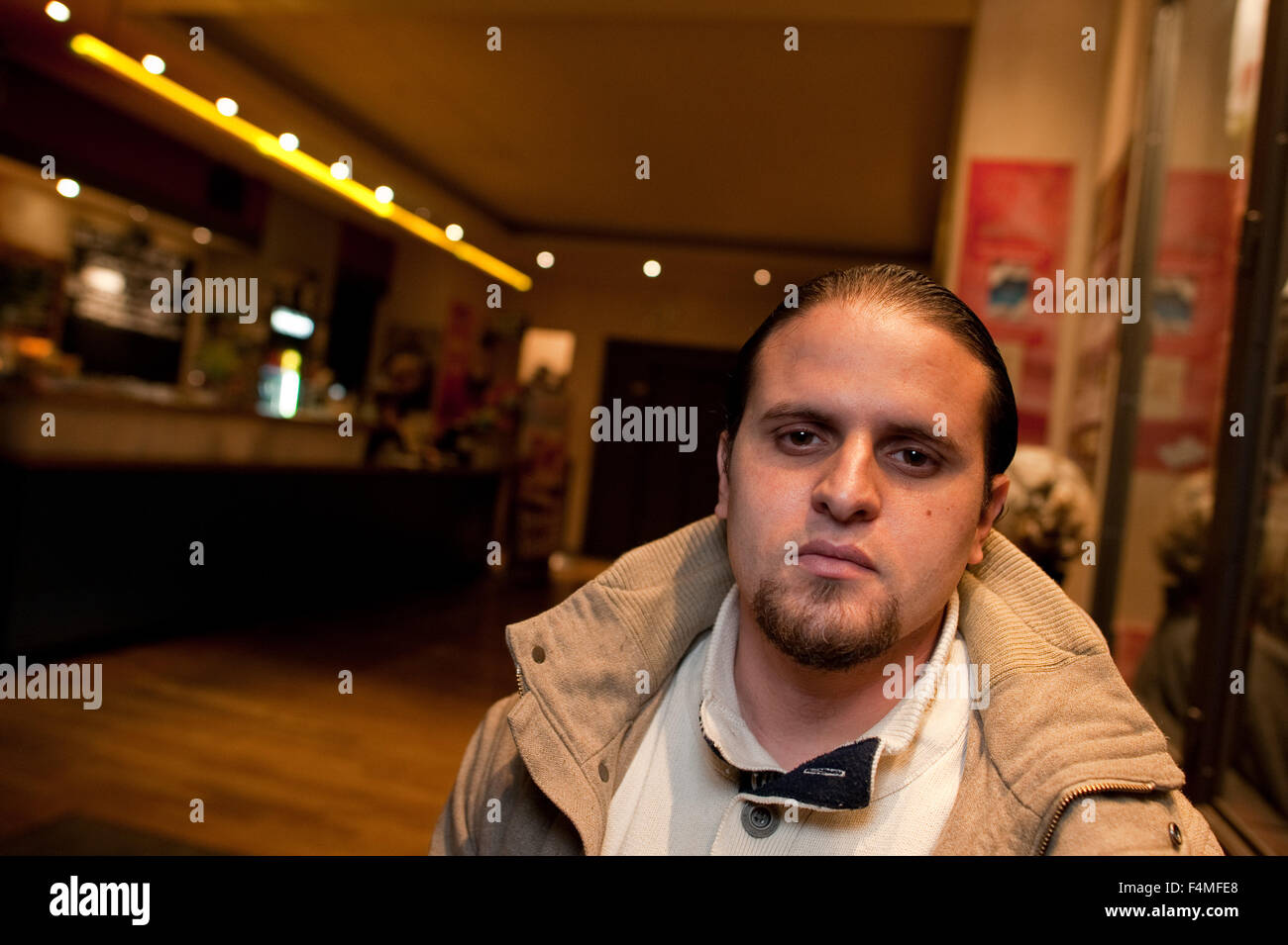 Berlin, Germany. 19th Oct, 2015. Guantanamo torture victim Mourad Benchellali sits in the lobby of a cinema in Berlin, Germany, 19 October 2015. The former inmate of the Guantanamo Bay detention camp met with representatives of Amnesty International and Human Rights Watch at this location to discuss further proceedings in his and other similar cases and took part in a panel discussion. Photo: Klaus-Dietmar Gabbert/dpa/Alamy Live News Stock Photo