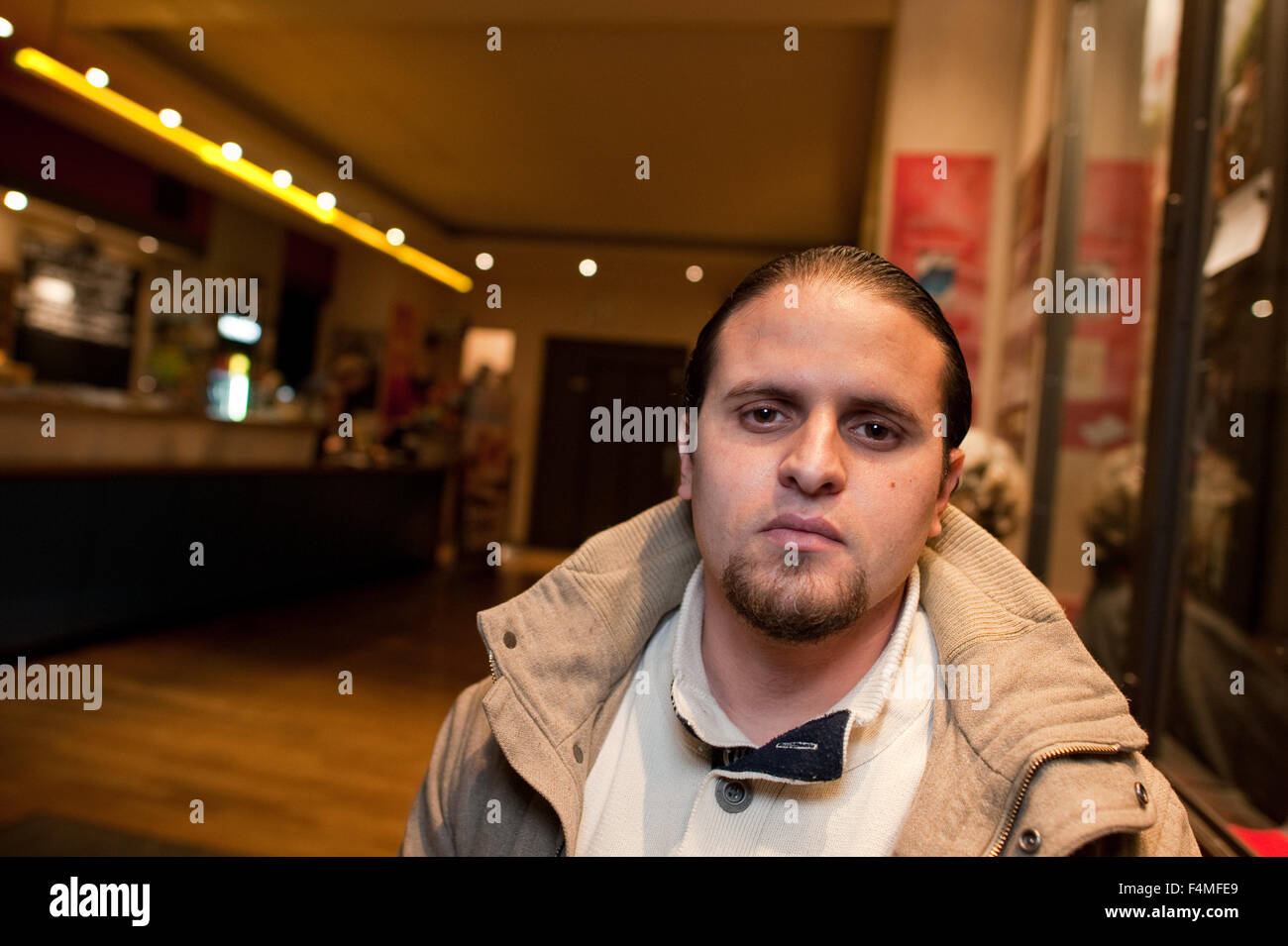 Berlin, Germany. 19th Oct, 2015. Guantanamo torture victim Mourad Benchellali sits in the lobby of a cinema in Berlin, Germany, 19 October 2015. The former inmate of the Guantanamo Bay detention camp met with representatives of Amnesty International and Human Rights Watch at this location to discuss further proceedings in his and other similar cases and took part in a panel discussion. Photo: Klaus-Dietmar Gabbert/dpa/Alamy Live News Stock Photo