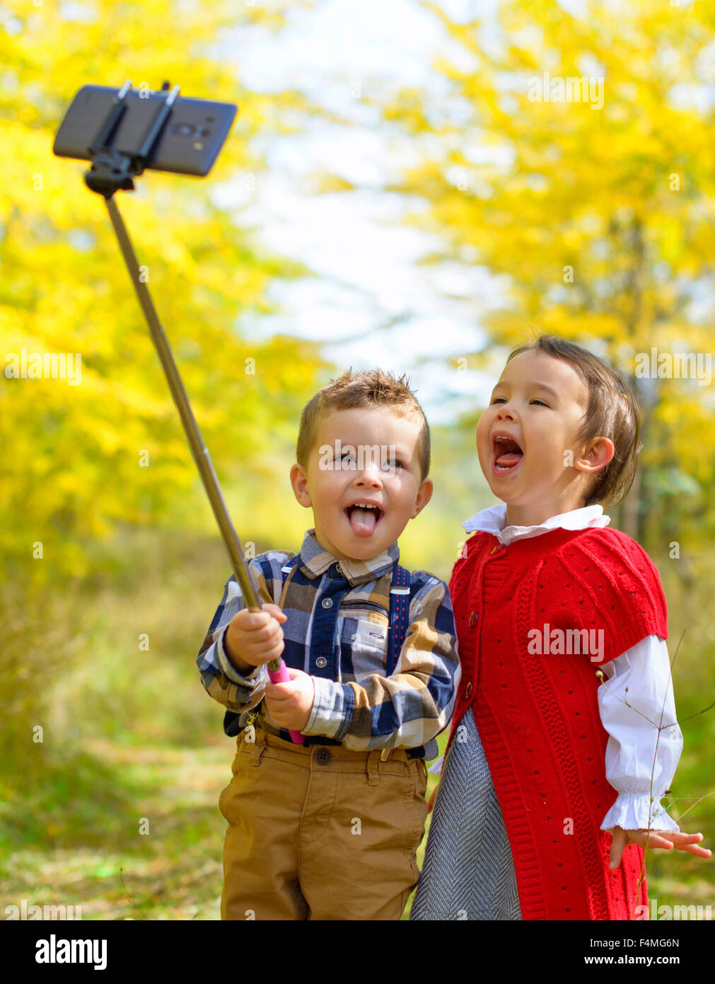 Two little kids taking selfie in park Stock Photo