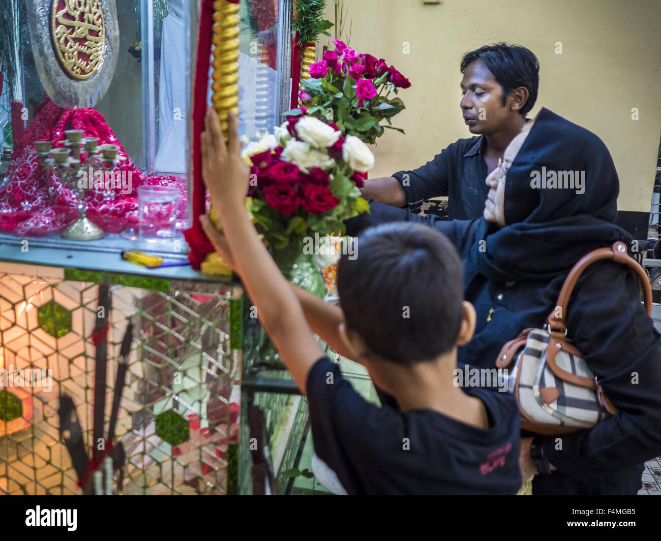 Yangon Division, Myanmar. 20th Oct, 2015. People pray at a shrine for Hussein ibn Ali at Punja Mosque in Yangon. Ashura commemorates the death of Hussein ibn Ali, the grandson of the Prophet Muhammed, in the 7th century. Hussein ibn Ali is considered by Shia Muslims to be the third imam and the rightful successor of Muhammed. He was killed at the Battle of Karbala in 610 CE on the 10th day of Muharram, the first month of the Islamic calendar. According to Myanmar government statistics, only about 4% of the population is Muslim. Credit:  ZUMA Press, Inc./Alamy Live News Stock Photo