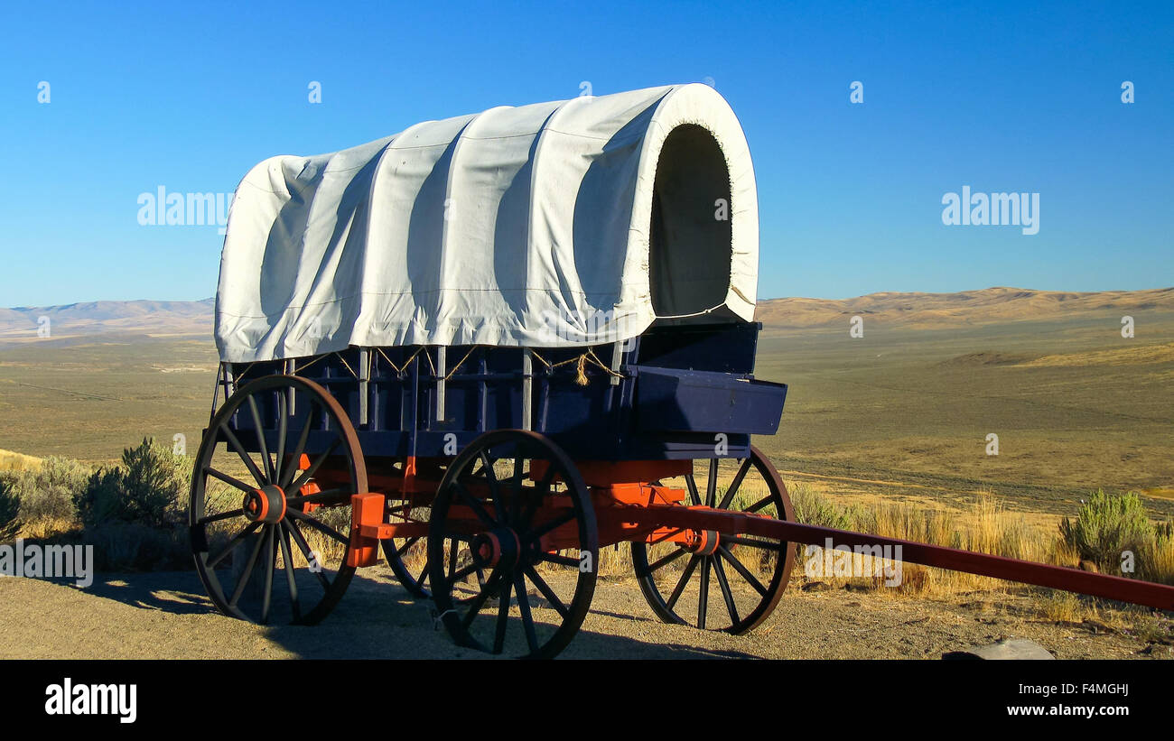 A covered wagon along the Oregon Trail with the Oregon prairie in background Stock Photo