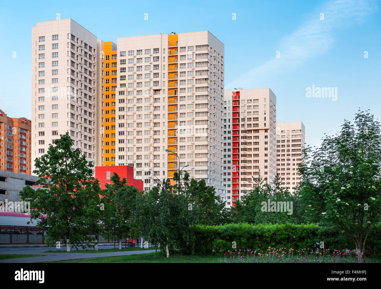 New high-rise residential building in Moscow suburb during golden hour Stock Photo