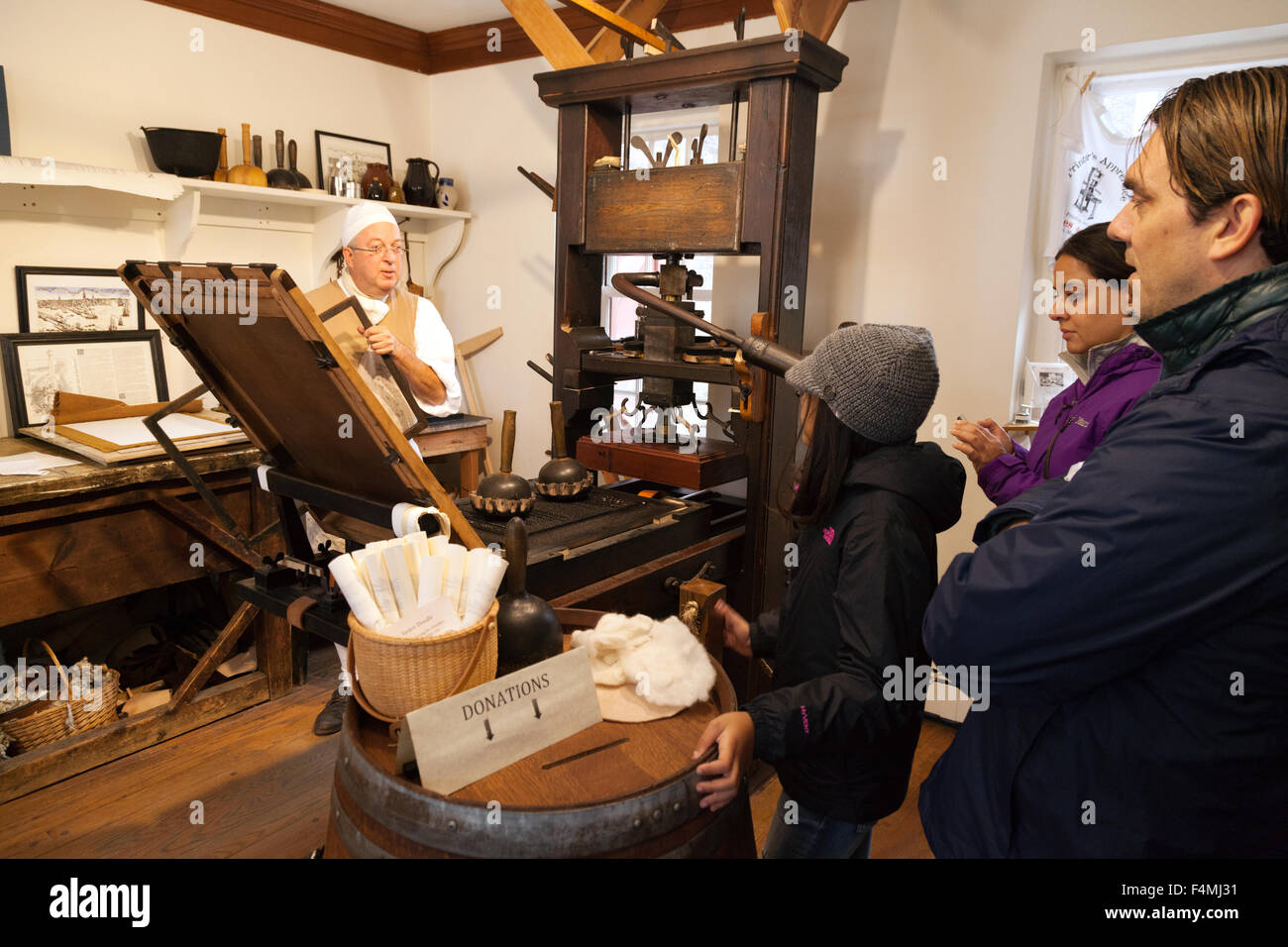 Tourists looking at a demonstration of 18th Century printing, Edes and Gill printers demonstration, Boston Massachusetts USA Stock Photo