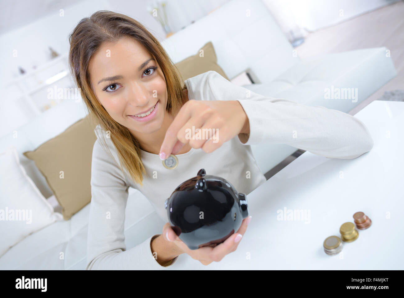 Woman with a piggy bank Stock Photo - Alamy