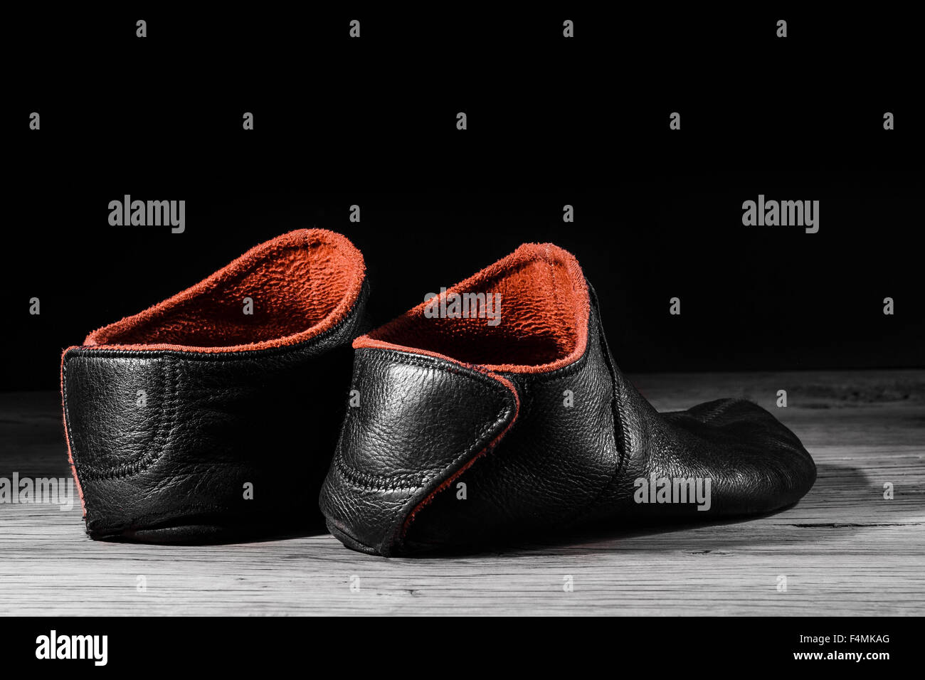 Empty slipper shoe design at home in creative light. Concept relax, weekend, rest. On black background. Stock Photo