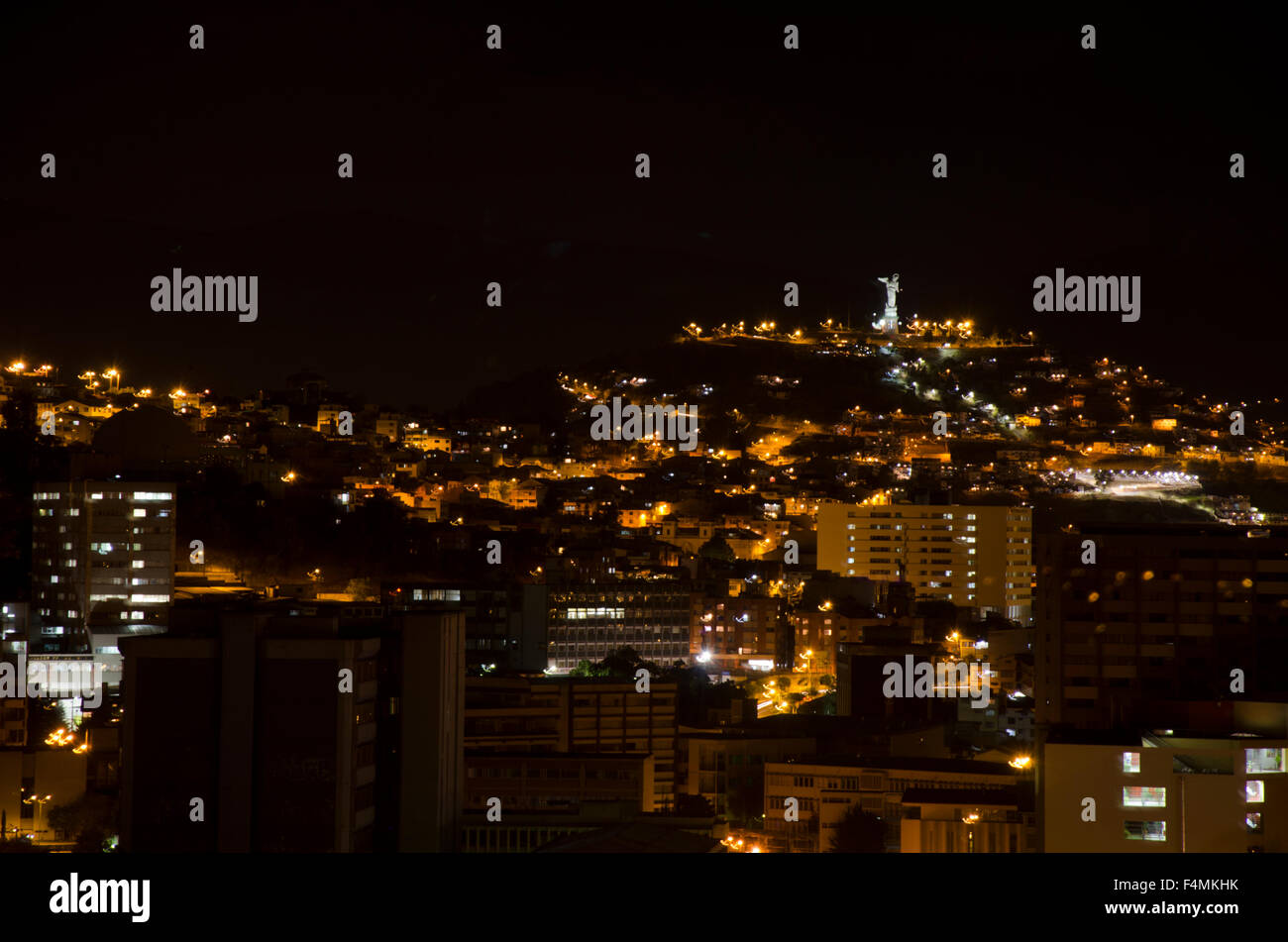 View of Quito, including the Virgin of the Pancellio, at night Stock Photo