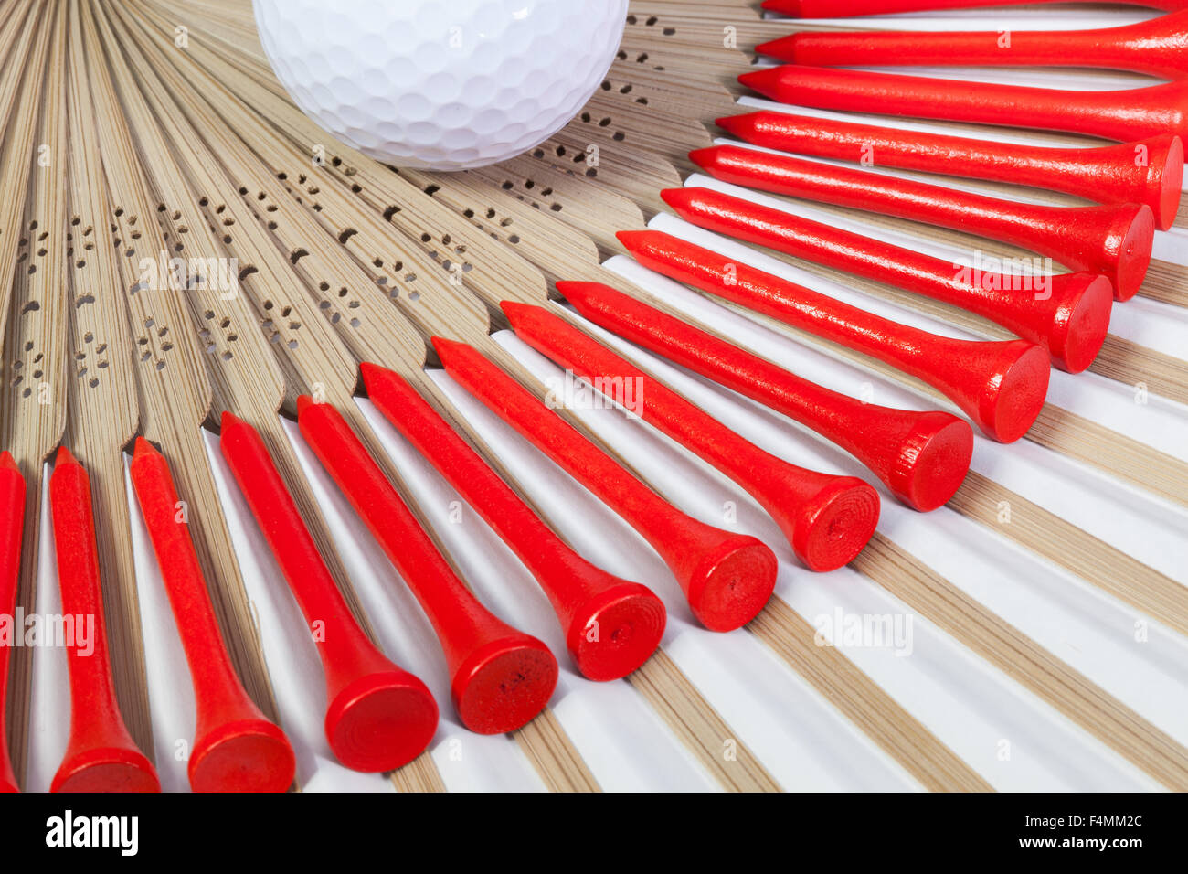 Typical Japanese hand fan made of bamboo and golf equipments Stock