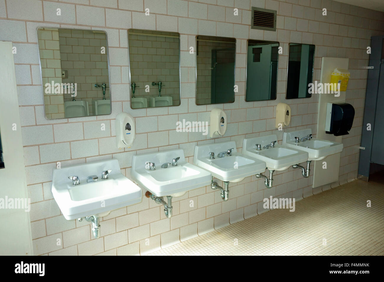 A row of sinks in a public washroom bathroom, restroom, latrine, comfort room, powder room, toilet room, W.C. Stock Photo