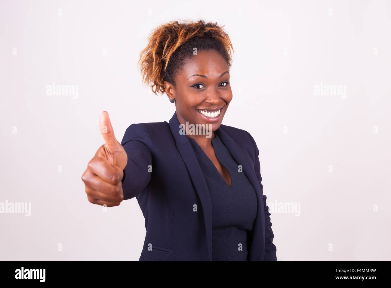 African American business woman making thumbs up gesture - Black people ...