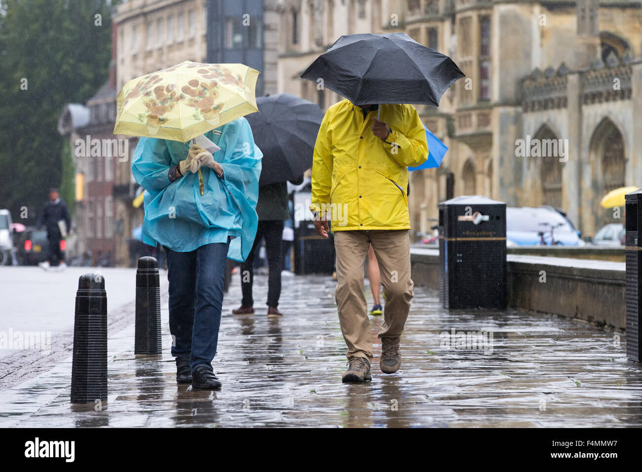 People punting on the River Cam in Cambridge in the rain under ...