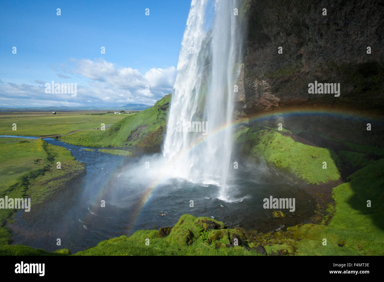 Rainbow beneath 60m-high Seljalandsfoss waterfall, Sudhurland, Iceland. Stock Photo