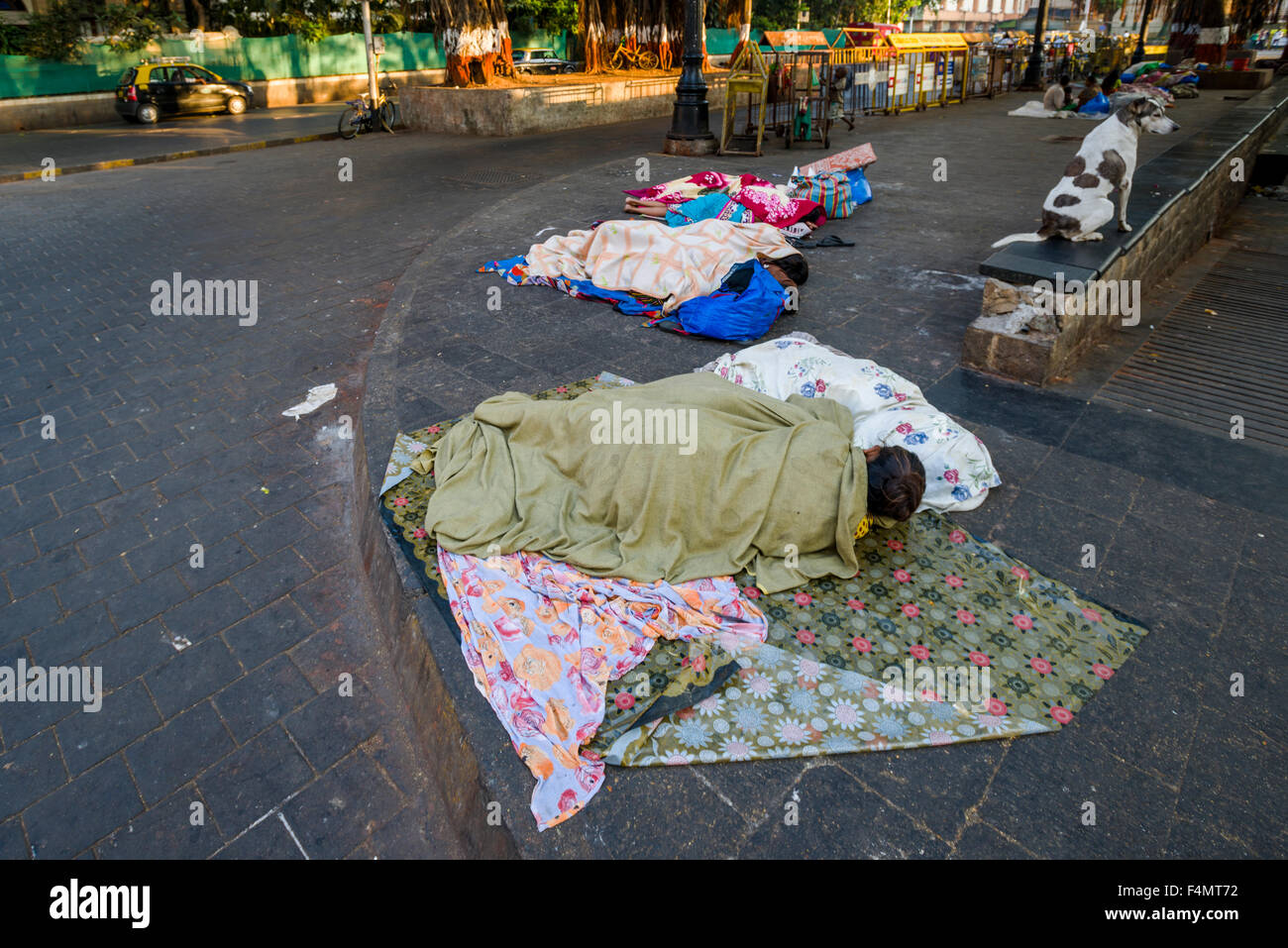 Homeless people are living under extrem conditions, sleeping on the pedestrian path Stock Photo