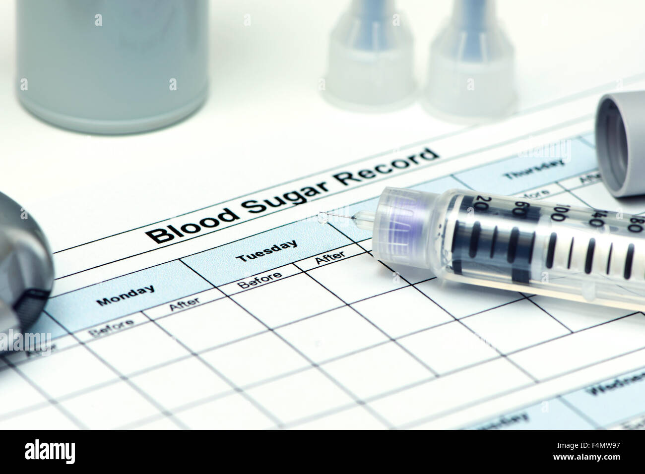 Insulin pen with blood sugar record and diabetic supplies Stock Photo