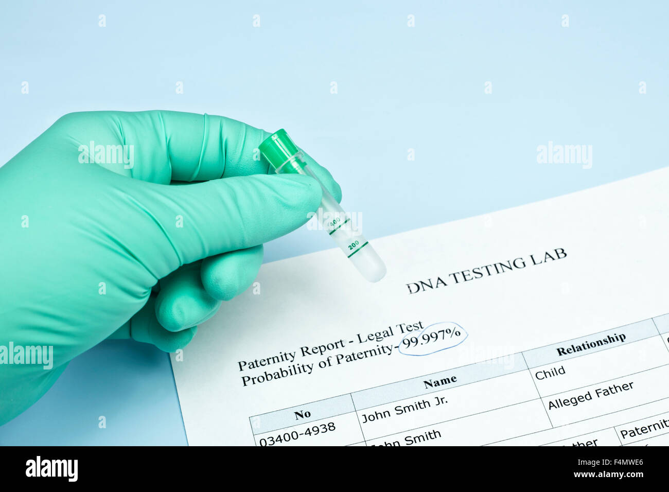 Paternity test results with technician holding lab sample. Stock Photo