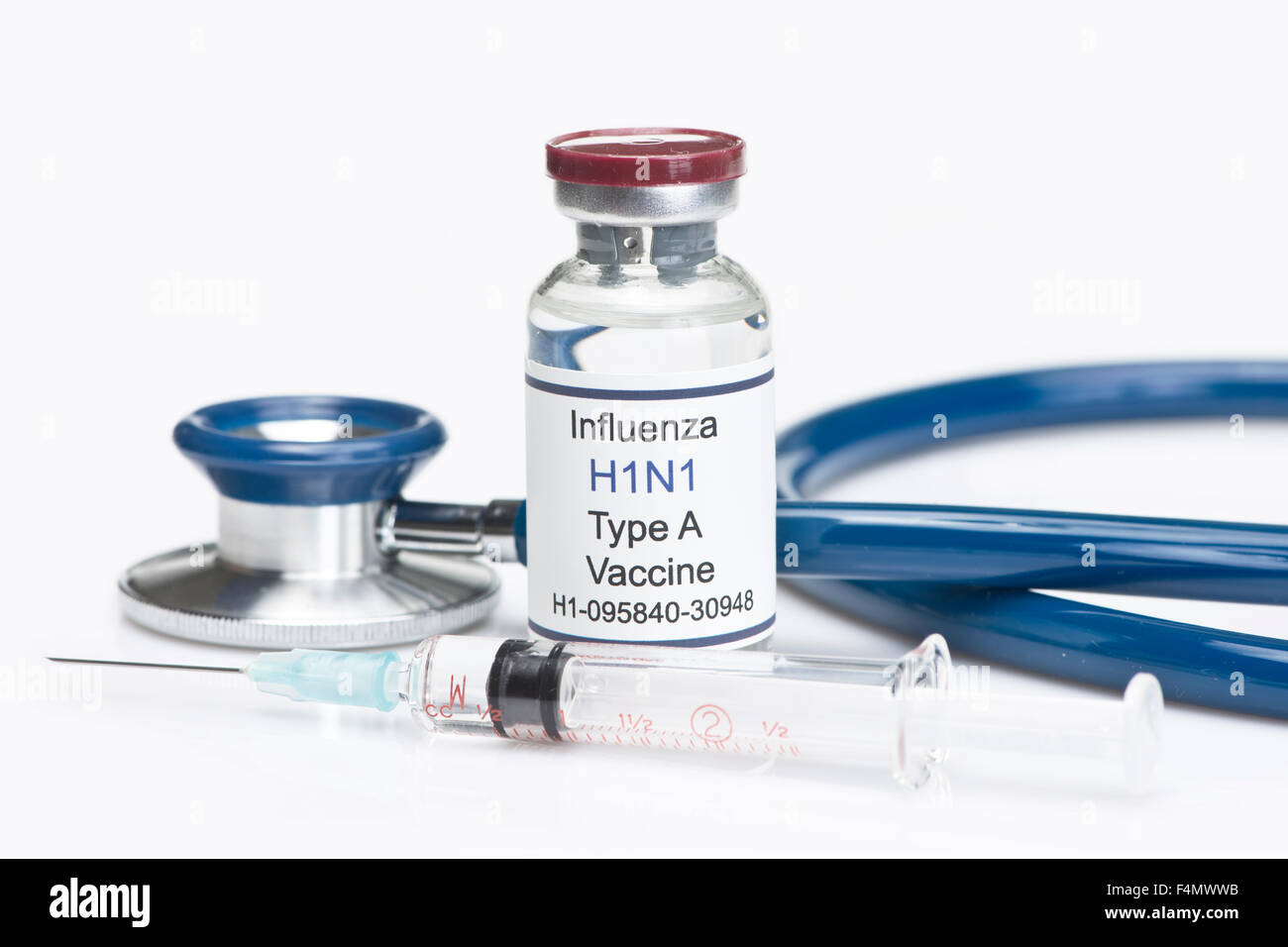 H1N1 influenza virus vaccination with syringe and stethoscope. Stock Photo