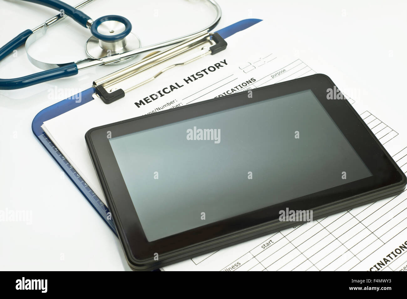 Personal computing device with stethoscope and patient medical record. Stock Photo