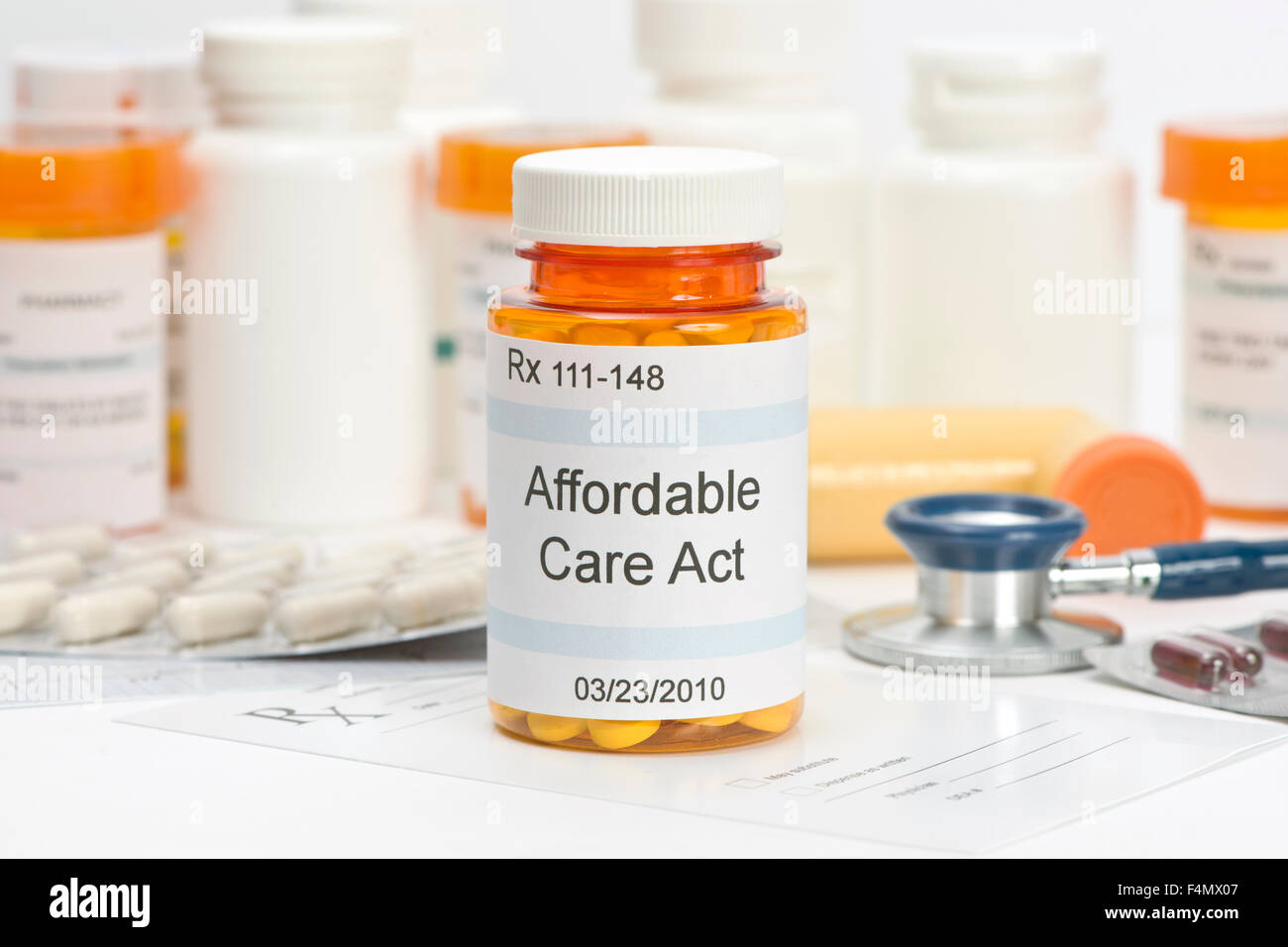 Affordable Care Act pill bottle with prescription and medical supplies.  Labels and all information contained therein are fictit Stock Photo