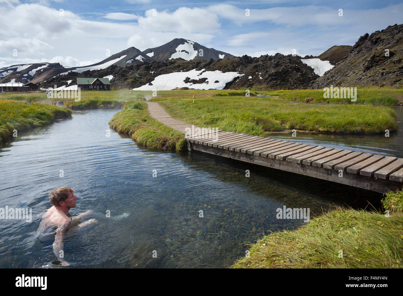 Swimmer enjoying the hot springs at Landmannalaugar, Sudhurland, Iceland. Stock Photo