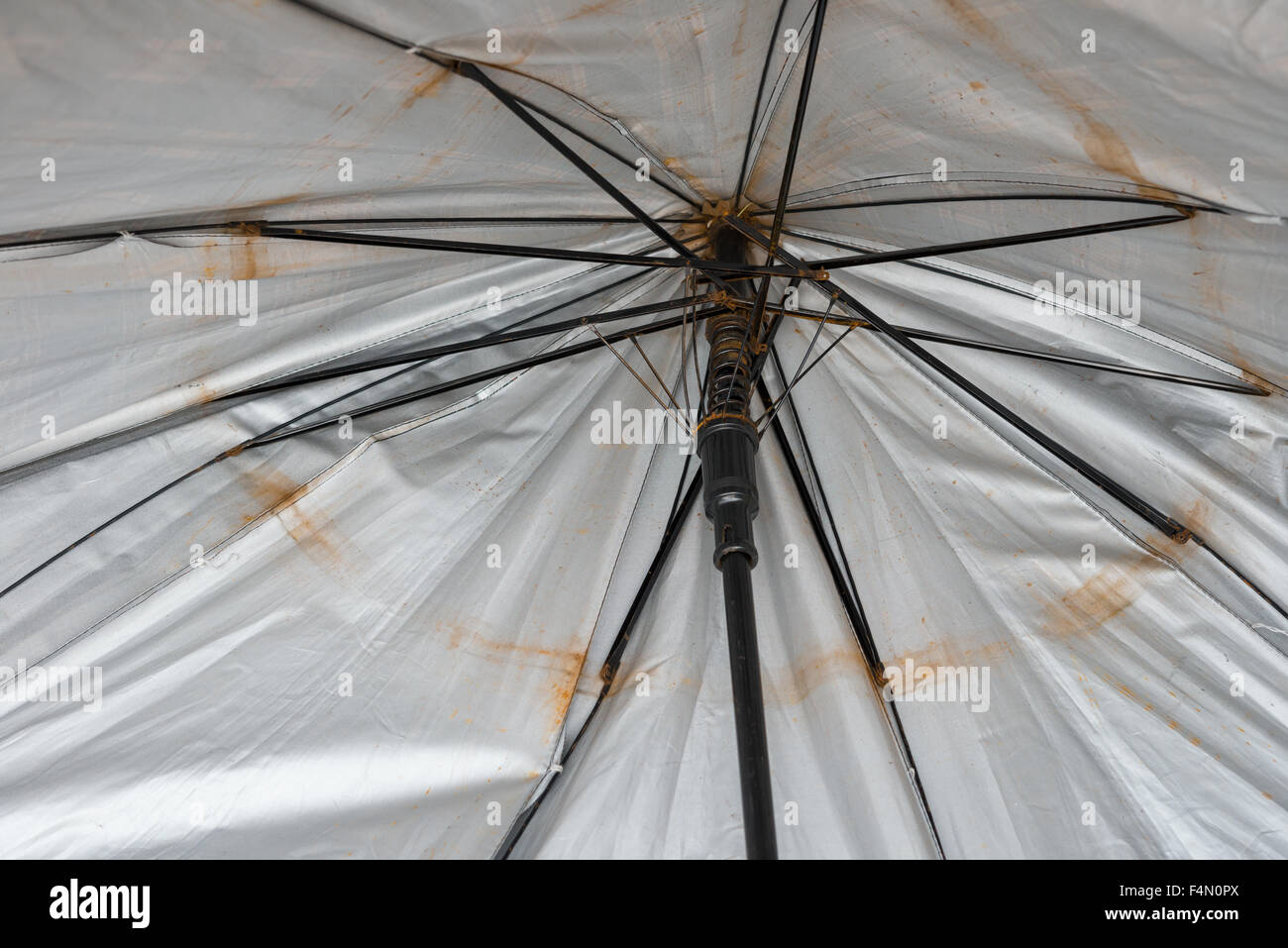 rusty and broken umbrella inside Stock Photo