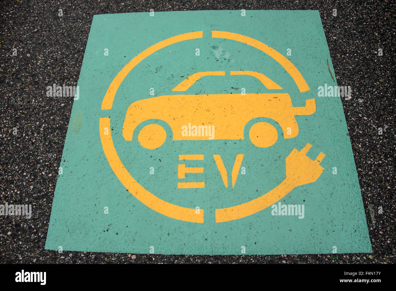 Pavement sign indicating only electric vehicles can park in this space. Stock Photo