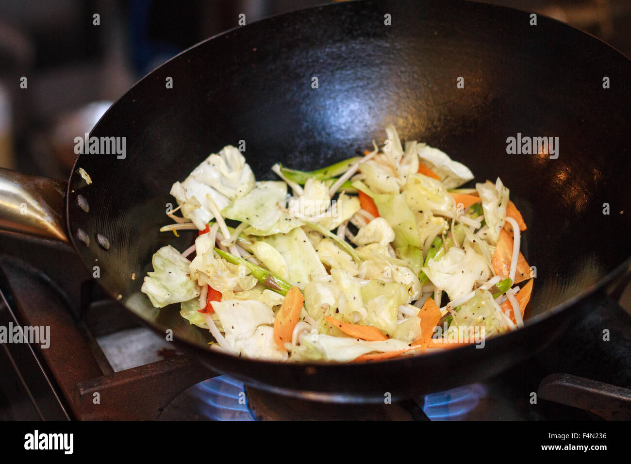 Chef making vegetable Stir Fry on a wok Stock Photo Alamy