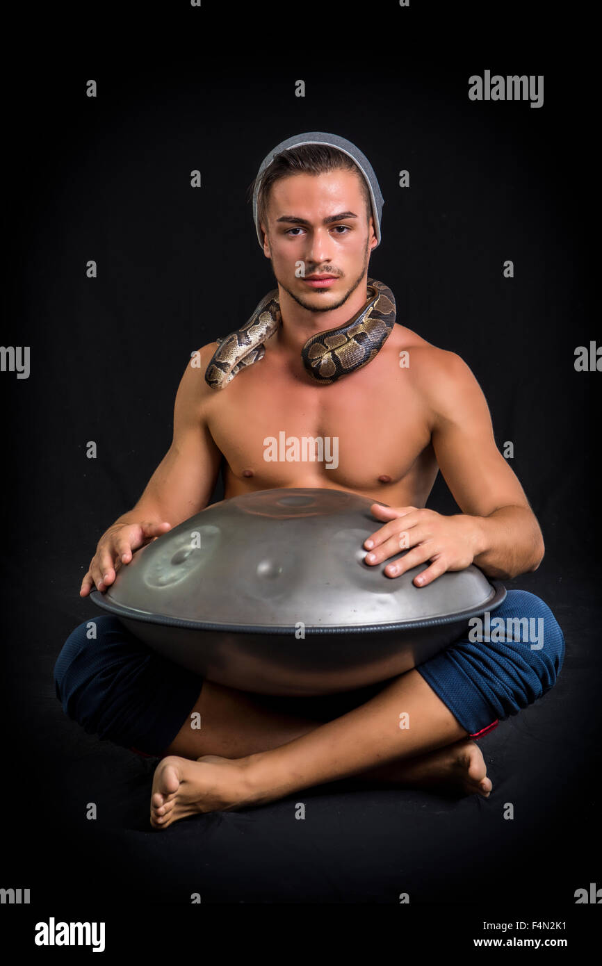 Exotic Male Drummer Drumming with Hands on Steel Pan Drums, While