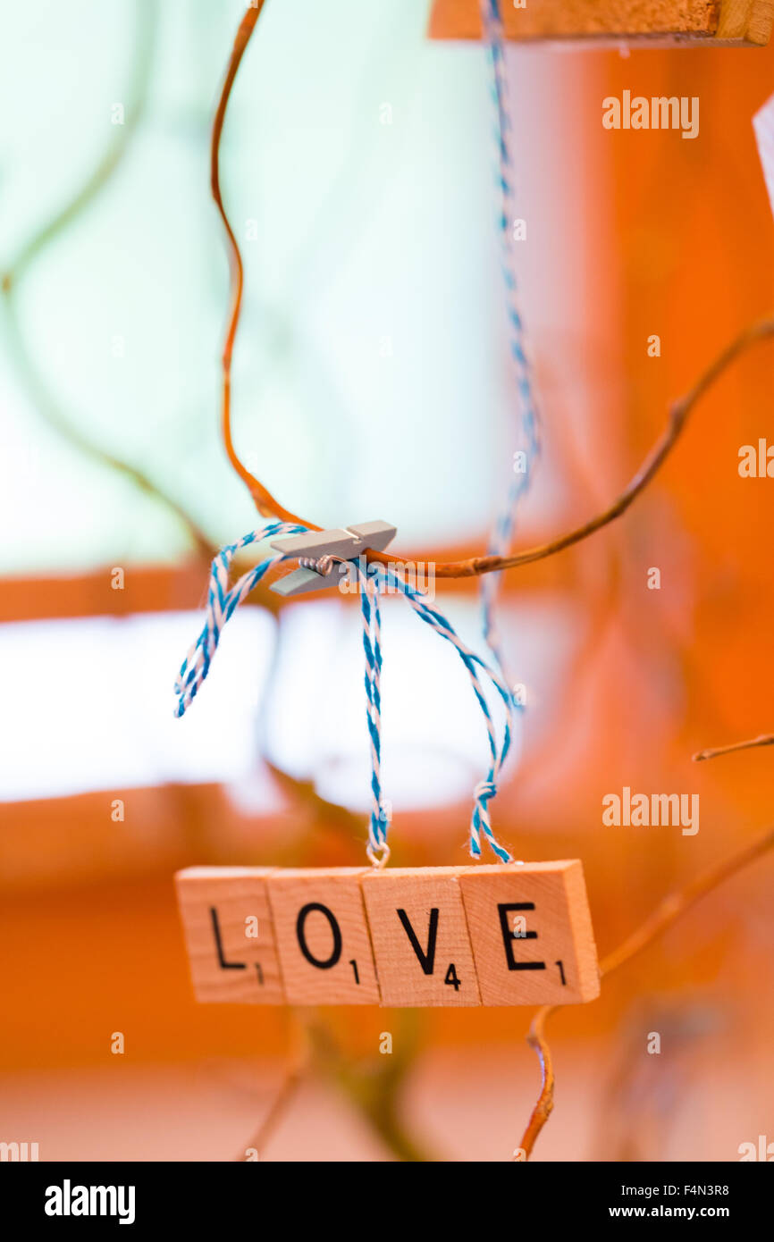 Scrabble letters at a wedding reception are used as decor to spell out the word love. Stock Photo