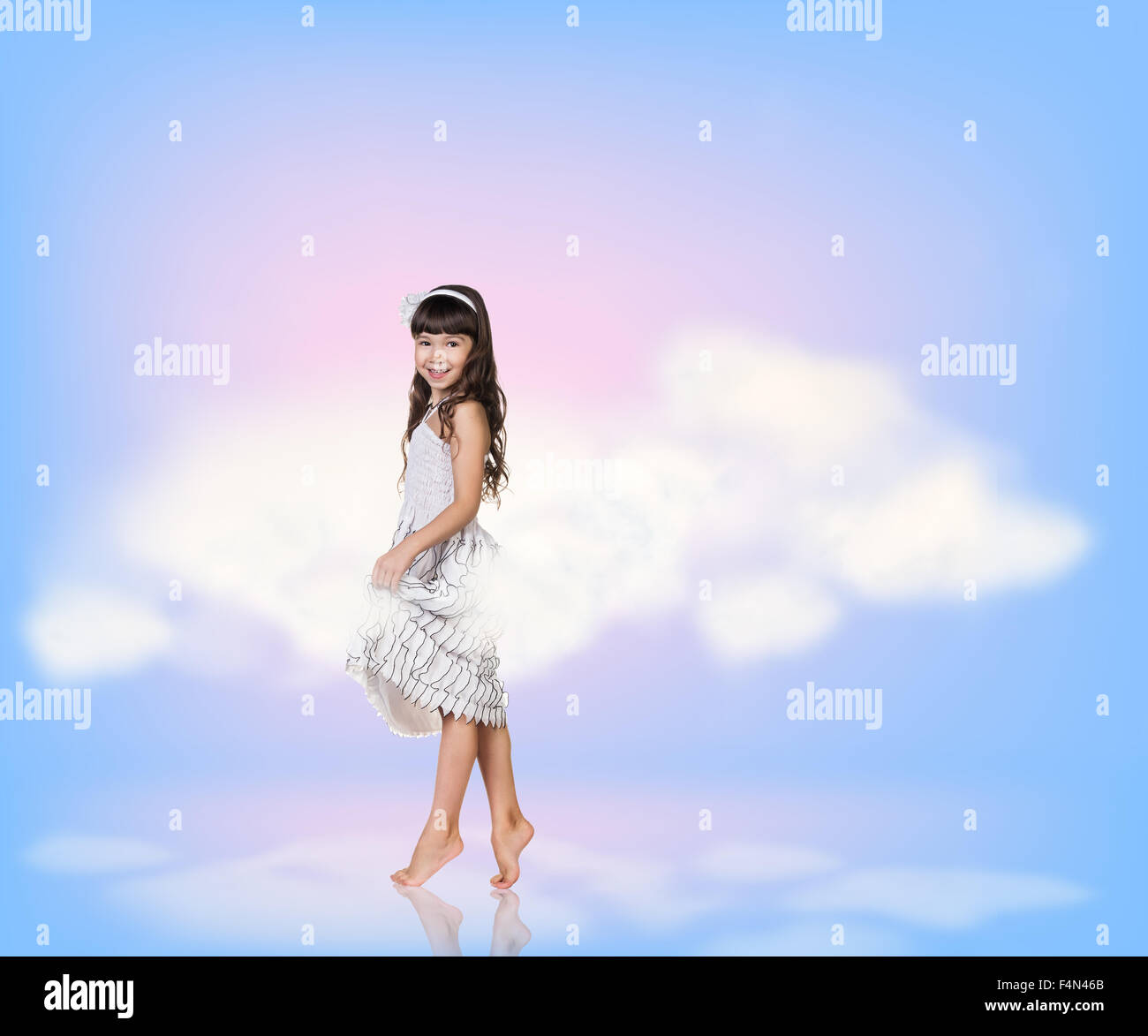 Little girl in sky clouds Stock Photo