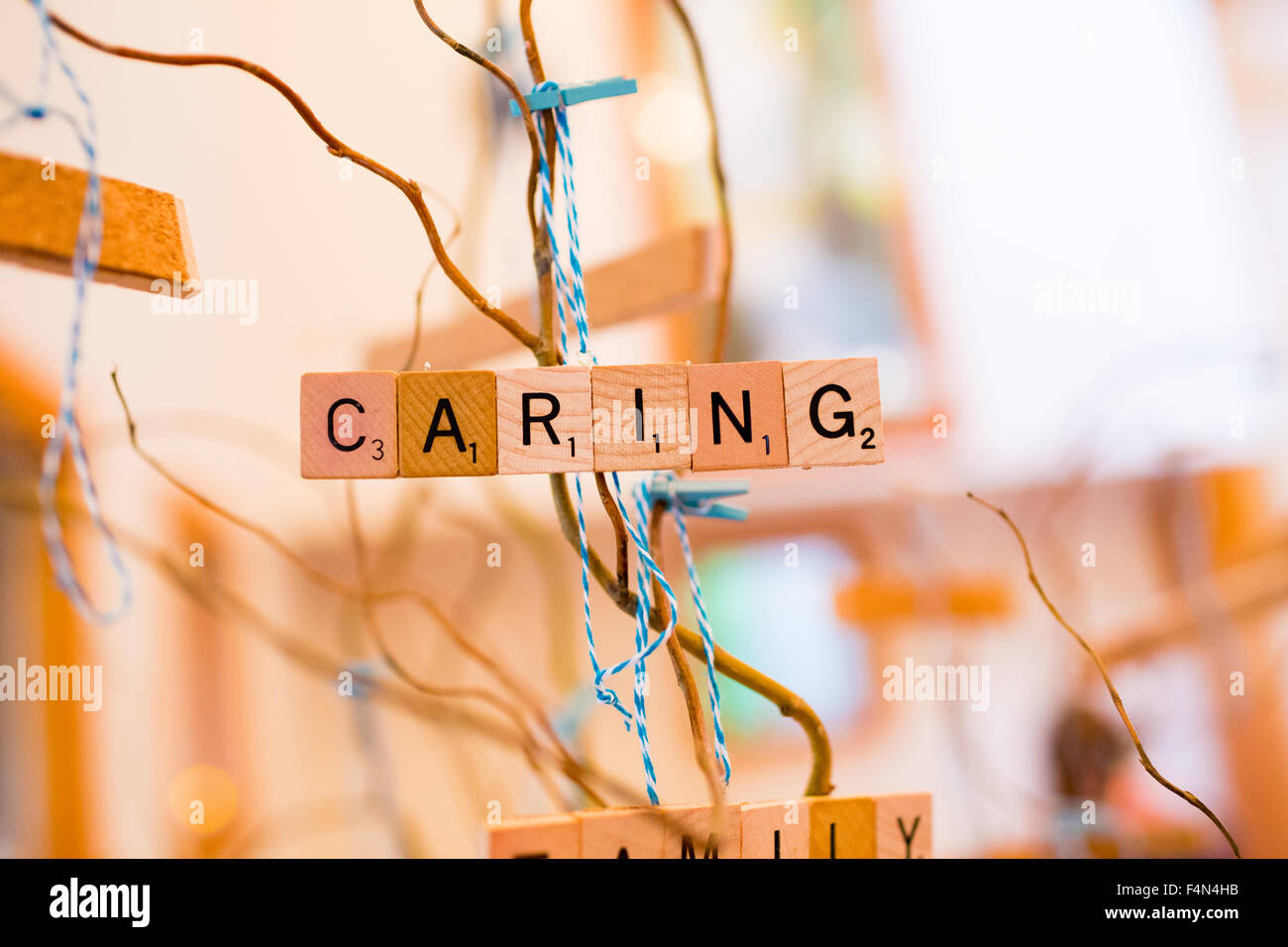 Scrabble letters at a wedding reception are used as decor to spell out the word caring. Stock Photo